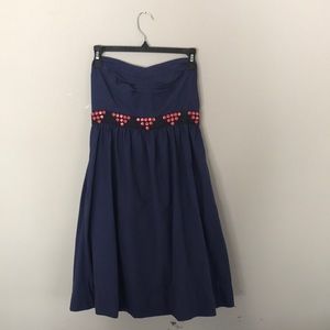 Navy blue strapless dress with pink patterned belt